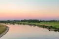 The old dutch river ijssel in the province of gelderland near the city of zutphen during sunset